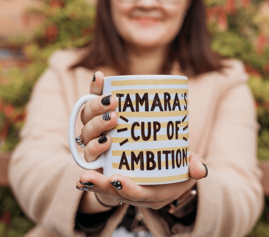 A photo of a mug with the words "Tamara's cup of ambition" written on it